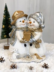 Poster - Two snowmen holding a box and a bird