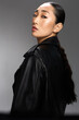 © SHOTPRIME STUDIO - Asian woman in black leather jacket with ponytail looking to the side fashionable and stylish portrait of a young asian female