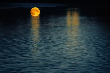 Wall Mural - Reflective water and a full moon for a feeling of peace and introspection.