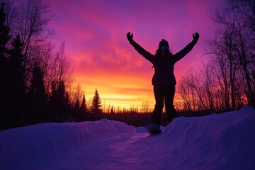Poster - A silhouette of a person celebrating against a vibrant sunset in a snowy landscape.