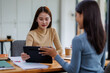 © David - Two asian female creative agency casual meeting discussion working with laptop, analyze planning and financial statistics and investment market at office.
