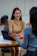 © David - Two asian female creative agency casual meeting discussion working with laptop, analyze planning and financial statistics and investment market at office.