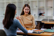 © David - Two asian female creative agency casual meeting discussion working with laptop, analyze planning and financial statistics and investment market at office.