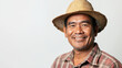© Keopaserth - smiling Filipino farmer wearing straw hat and plaid shirt, showcasing warm expression. His joyful demeanor reflects connection to his agricultural roots
