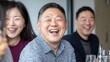 © EchoFrame - Joyful group of friends sharing laughter and happiness at a dinner table