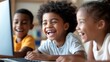 © M2A - Three cheerful kids sharing a moment of laughter and joy as they engage with a laptop in a bright and inviting indoor environment, highlighting the joy of learning together.