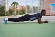 © alvaro - Young black man doing calisthenics plank in a park