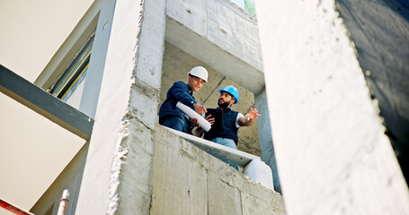 Poster - Businessmen, civil engineer and building with blueprint for industrial development or construction safety in city. Low angle, male people or architect with helmet or floor plan for architecture