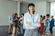 © Jacob Lund - Young businesswoman standing confidently at conference with coworkers in office setting