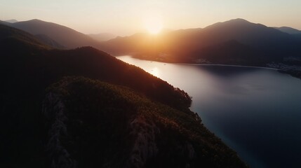Wall Mural - sunset over a tranquil lake surrounded by mountains and hills in the early evening light