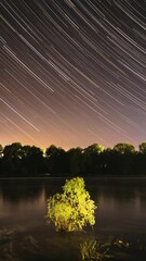 Wall Mural - Meditation By The Water. 4k Hyperlapse Meteors Fly Across The Night Sky. Night Sky Above River. From Dusk To Dawn. Stars Float Across Sky. Night Sky Turns Into Morning. Dawn Is Coming. Calmness And