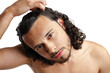 © fotofabrika - Young man with curly hair thoughtfully posing against a plain background