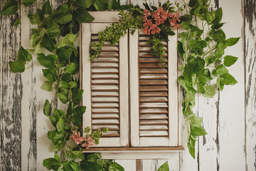 Poster - A distressed white wooden shutter repurposed as a decorative wall piece.