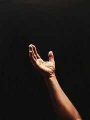 Wall Mural - hand reaching out towards an unseen destination in a dark setting