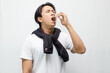 © Teo - Young Asian Man Coughing and Showing Symptoms of Flu with Fever