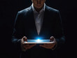 © Vasili - A man in a suit holding a glowing tablet in a dark background. The futuristic feel highlights innovation and technology in a sleek, modern style.