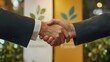 © Prostock-studio - Two professionals engage in a handshake to signify partnership in advancing artificial intelligence within sustainable finance.