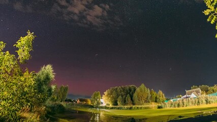 Wall Mural - Rural Countryside Night Sky Time Lapse. Amazing Starry Effects. Meteor Trails On Night Sky Background. Timelapse Night Sky Above River. Amazing Summer Landscape With Reflection In River. Star Lines
