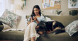 © peopleimages.com - Woman, phone and dog to relax in home, surfing dating website and online for companion search. Female person, reading ebook and app for communication on couch, pet care and internet for animal info