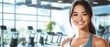 © Fernando - Smiling Fitness Woman in Modern Gym with Cardio Equipment