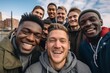 © Vorda Berge - Smiling diverse group of gay guys taking a selfie outdoors
