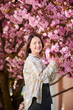 © anatoliy_gleb - Woman allergic enjoying after treatment from seasonal allergy at spring. Portrait of happy beautiful woman smiling in front of blooming sakura tree at springtime. Spring allergy concept.