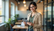 © Subrata Haldar - Confident Young Hispanic Businesswoman Standing in Office. Smiling Executive and Entrepreneur Using Tablet.