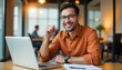 © Subrata Haldar - Confident Businessman Celebrating Success at Desk with Laptop and Documents, Modern Office Vibe.