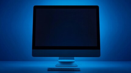 Aufkleber - A sleek computer monitor illuminated in blue light, showcasing a minimalist workspace.