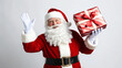 © Ali Khan - Isolated against a white background, Santa Claus smiles while holding a wrapped gift. PNG transparency.