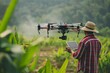 © Sunny - Farmer holding camera of professional drone flying over green cornfield, using modern technology in agriculture