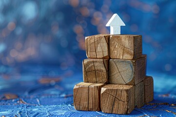 Poster - A stack of wooden blocks with a white arrow on top, ideal for illustrating concepts or pointing directions
