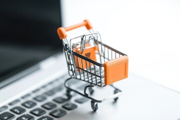 Poster - A miniature shopping cart sits atop a laptop, perfect for e-commerce concepts or technology-related scenes