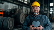 © Ed - Worker in construction overalls and yellow hard hat holds a heart-shaped valentine, copy space poster idea or postcard for Valentine's Day