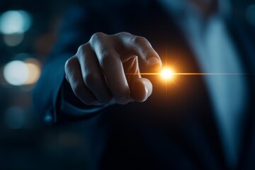Poster - Close-up of a person's hand reaching out to touch a glowing light in a darkened environment at night