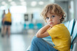 © Dawid - Concerned child sitting in a healthcare facility waiting for treatment