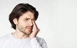 © Prostock-studio - Feeling unwell. Guy feels pain in his closed eyes and presses hand isolated on gray background, studio shot