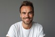 © Harsha - Smiling man in white shirt  close up portrait on gray background