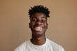 © Harsha - Happy African American Gen Z guy laughing  close up portrait.