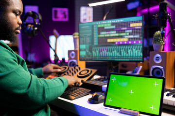 Leinwandbilder - Producer composer mixing and mastering his songs with stereo tools, copyspace screen on a tablet. Audio technician improving sound quality on tracks recorded in post production.