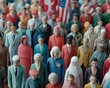 © Espresso - A diverse crowd of miniature figures representing various ethnicities and genders, dressed in vibrant colors.