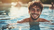 © Infinity Lens - Handsome happy young man smiling in a swimming pool water. copy space, summer vacation holiday hotel resort leisure, healthy weekend relaxation activity.