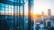 © sadewotito - Sunrise view through modern glass skyscraper windows, showcasing city skyline.
