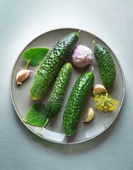 Fresh cucumbers and garlic on a plate.