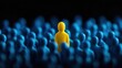 © Vadym - Yellow figure stands out amongst crowd of blue figures. Finding right people important in business. Photo illustrates key concept in business strategy, HR. Single person stands out representing