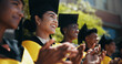 © peopleimages.com - Students, happy and applause at university for graduation, peer support or cheering for achievement. People, clapping or outdoor on campus for academic success, pride or smile for education milestone