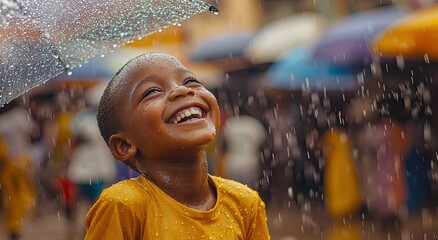 Wall Mural - African child laughing in the rain, wearing yellow hooded jacket