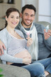 © auremar - young couple expecting baby smiling cheerful