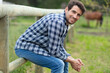 © auremar - handsome middle aged farmer sitting at fence