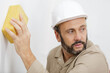 © auremar - a male builder washing wall